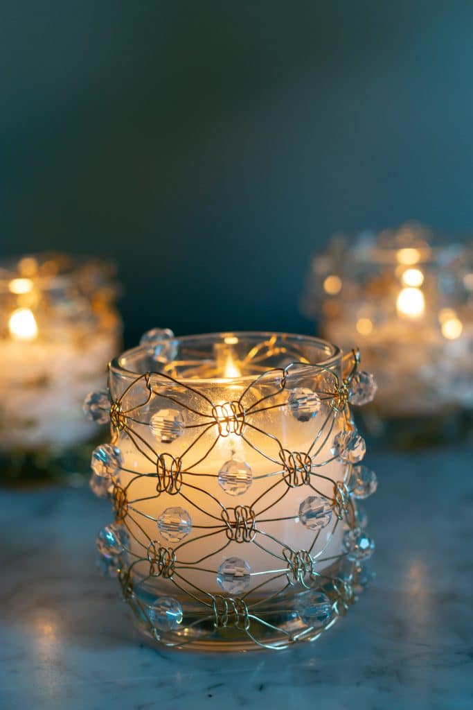 DIY Macrame Wire with beads covering a glass votive