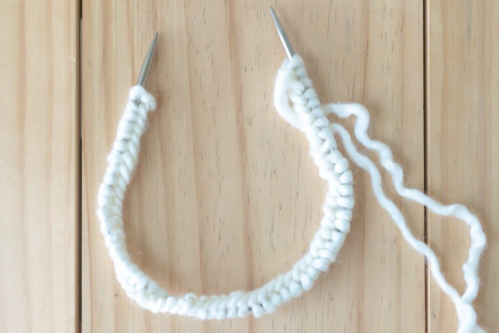 Twisted stitches on circular knitting needles.