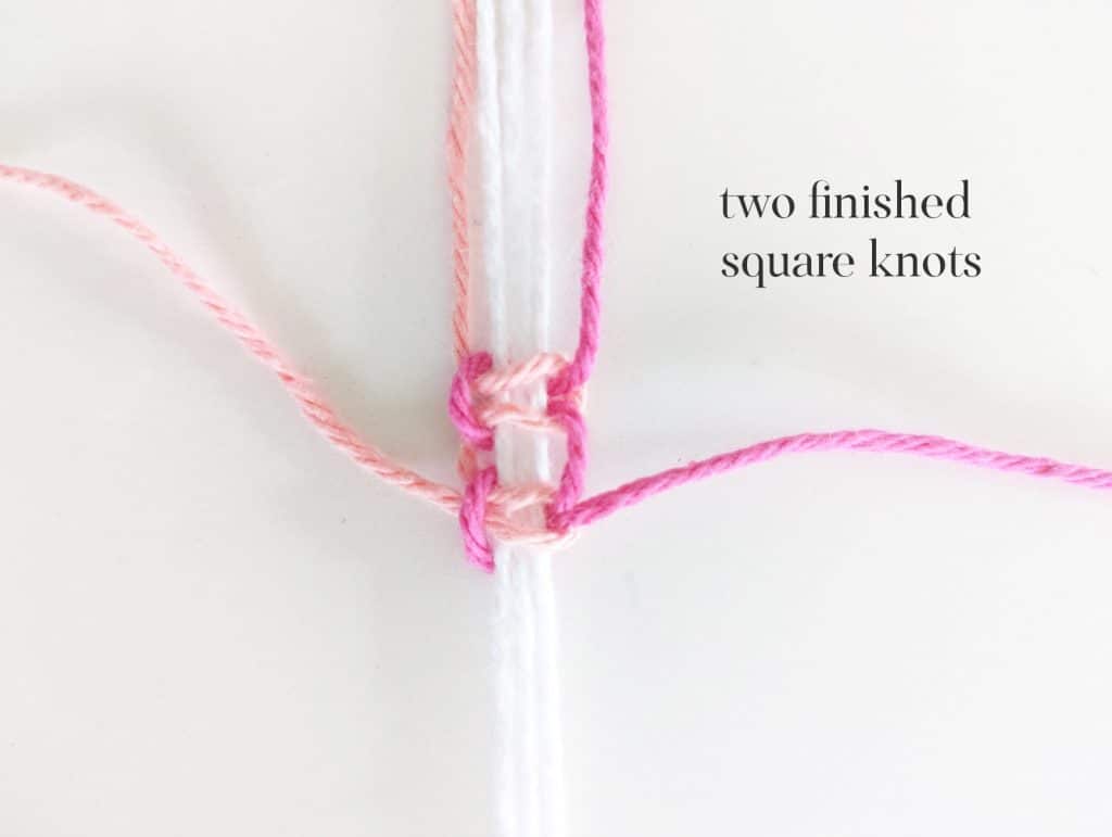 Two finished square knots with white, pink and salmon yarn.