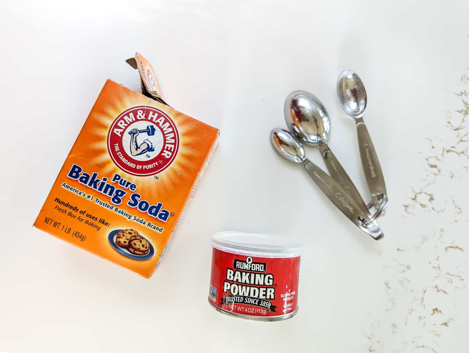 Box of baking soda and baking powder and measuring spoons.