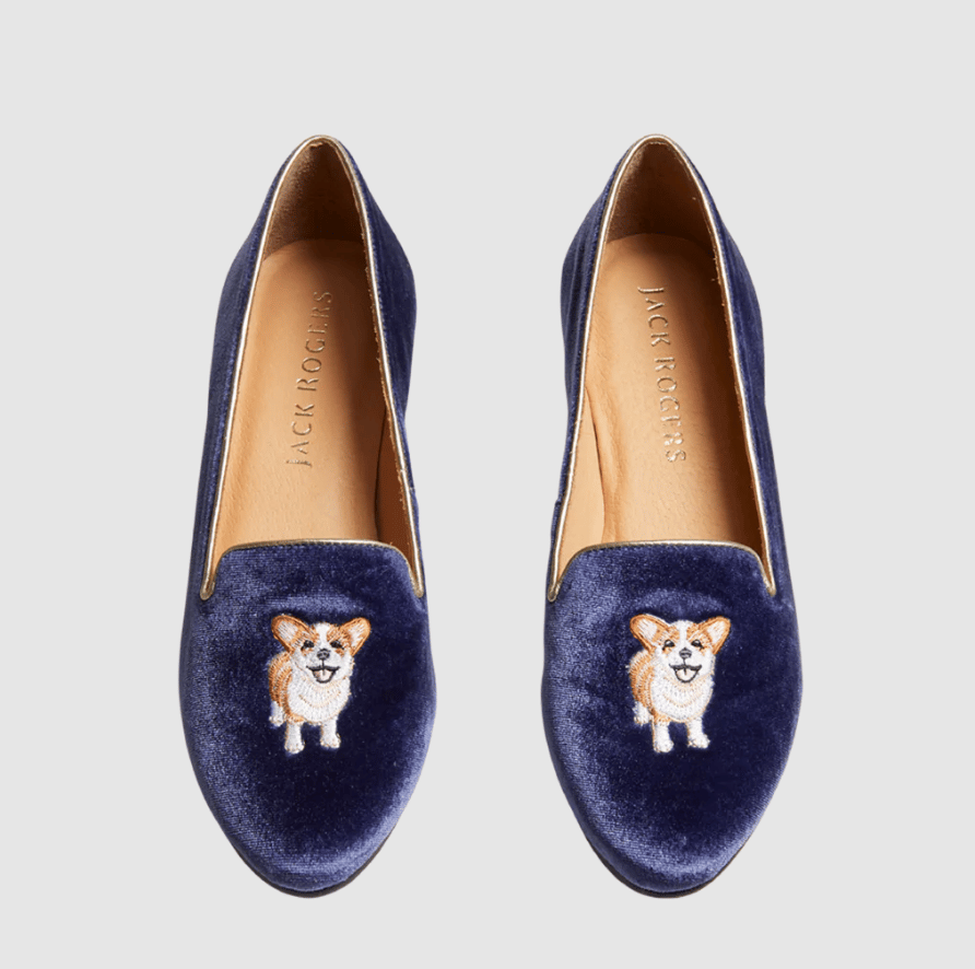 Blue shoes with corgi embroidered on them.