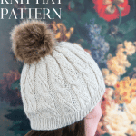 Cable Knit Hat on girl in front of painting.
