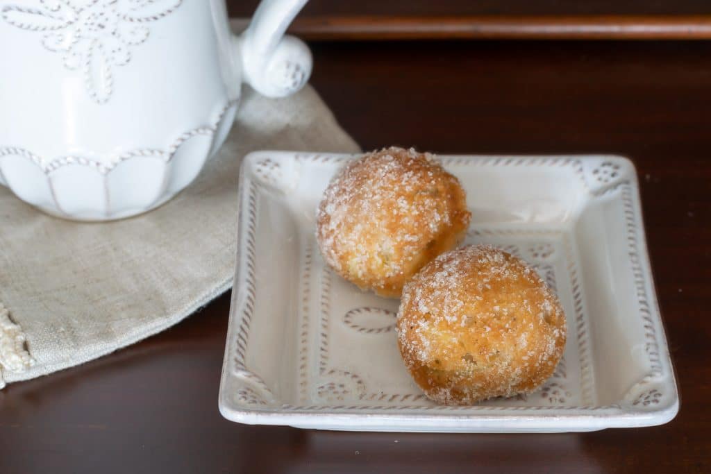two donut holes on a square plate.