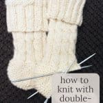 Knitting socks with double pointed needles.