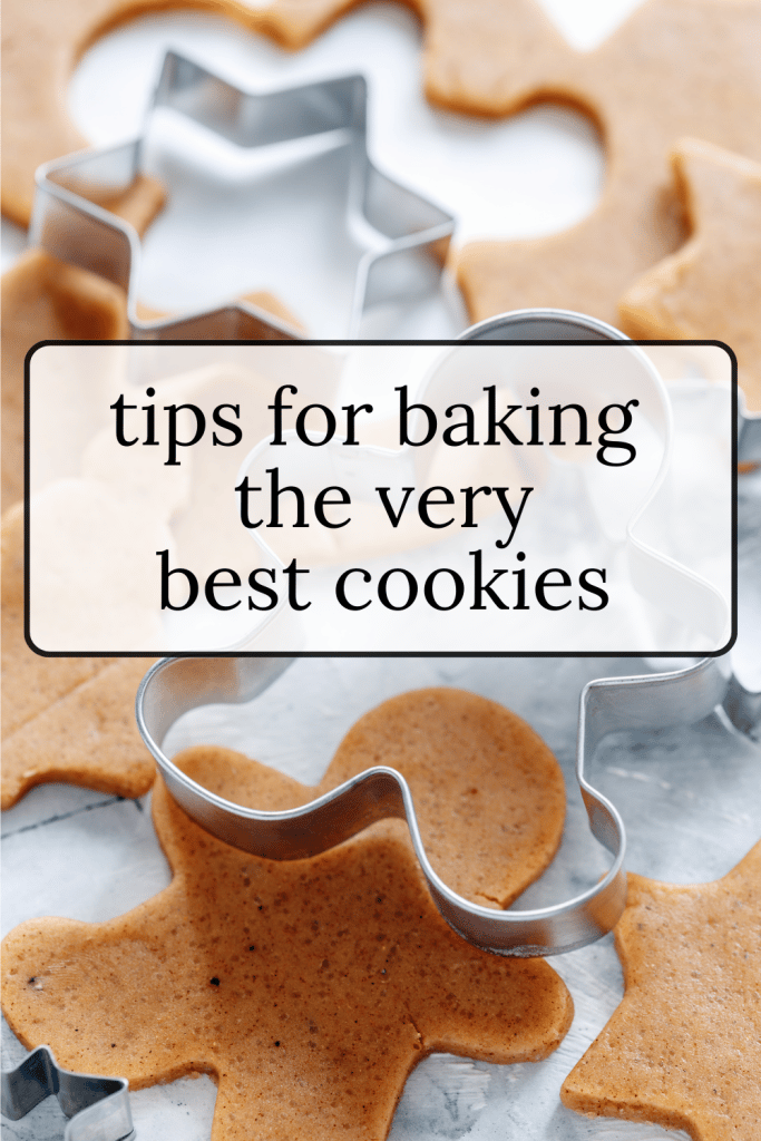 Cookie cutters and cut out cookie dough.