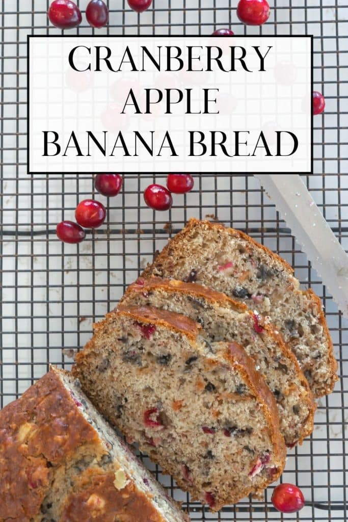 Sliced Cranberry, Apple and Banana Bread on a cooling rack with scattered cranberries.