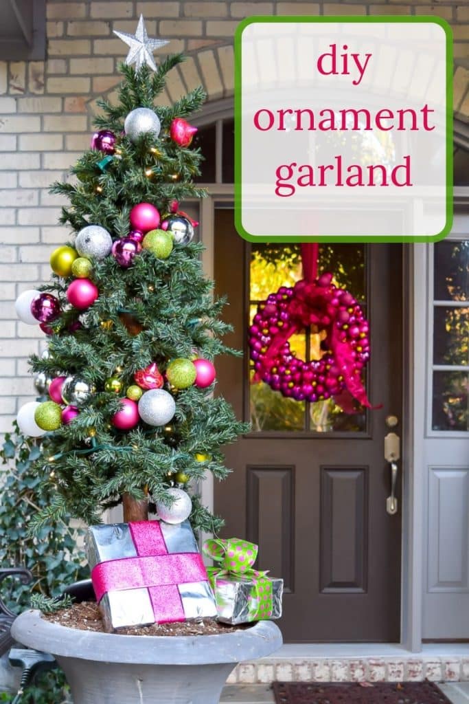 FRont porch with pink and green ornament garland.
