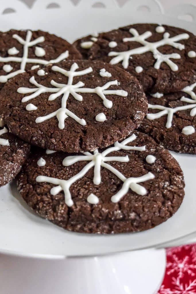 Chocolate Cookies with snowflakes drawn in icing.