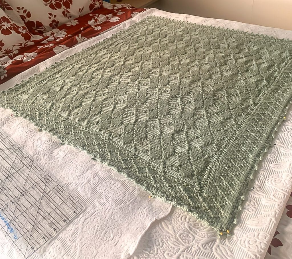 A pale green knit baby blanket.