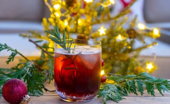 pomegranate cocktail in front of Christmas tree