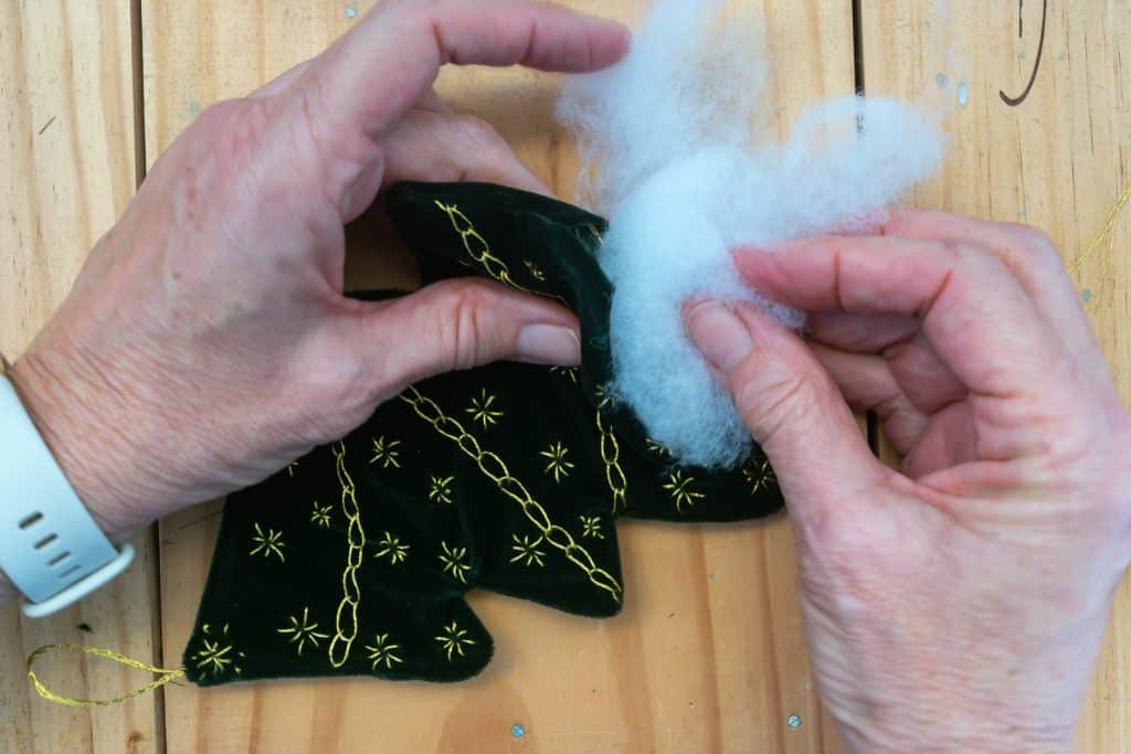 Stuffing embroidered Christmas Trees.