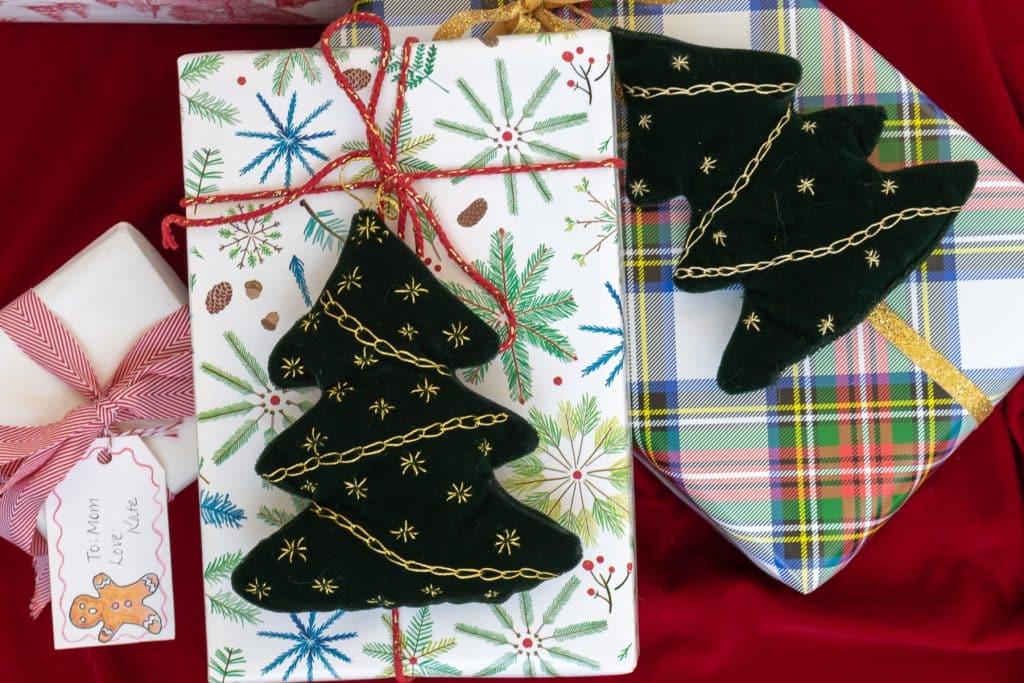 Embroidered Christmas Trees on wrapped packages.