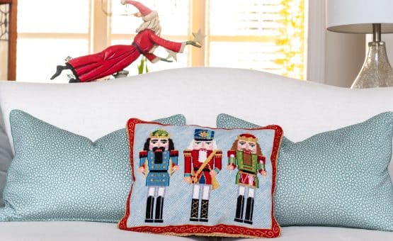 Pillow with Nutcrackers on a sofa.