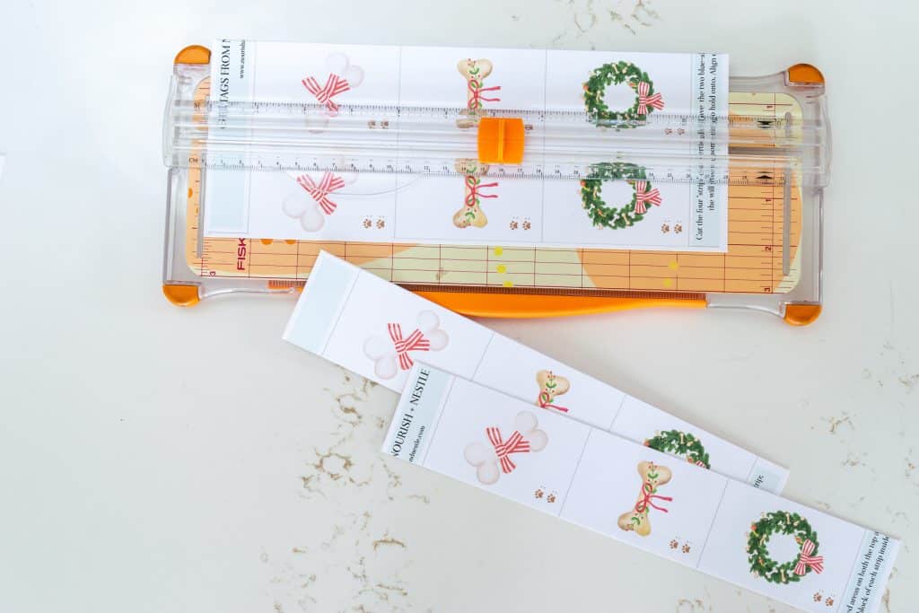 Cut the PDF of dog treat gift tags into strips.