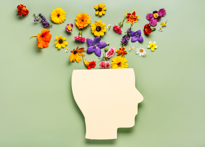A graphic of a head with flowers coming out of it.