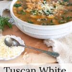 Bowl of Tuscan White Bean Soup in a white bowl with a bowl of parmesan cheese.