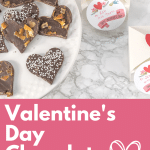 Valentine's Day Chocolate Bark on a white plate with gift boxes.