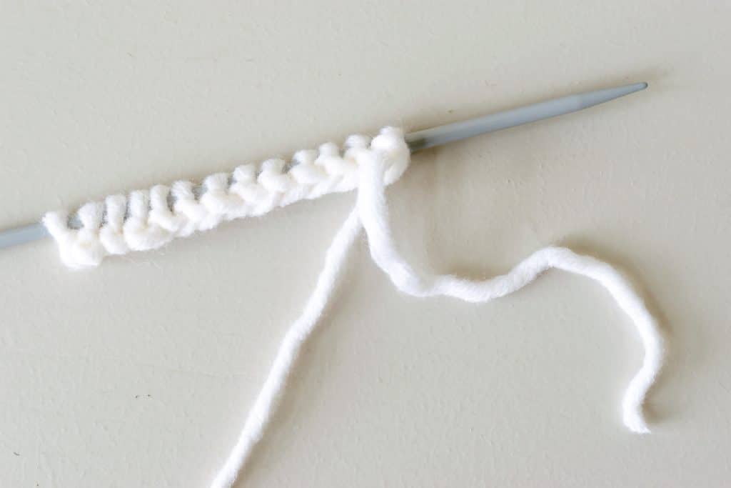 cast on stitches on a knitting needle.