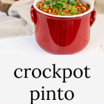 Red crockery filled with crock pot pinto beans.