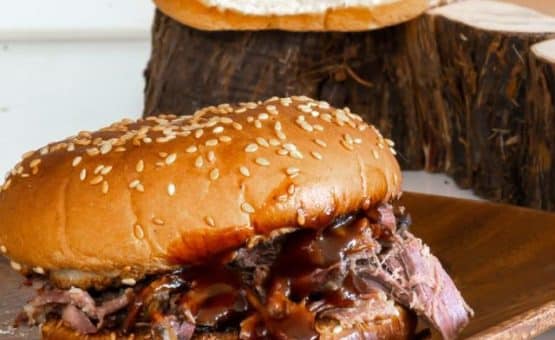 Sandwiches with slow cooker pulled beef and barbecue sauce.