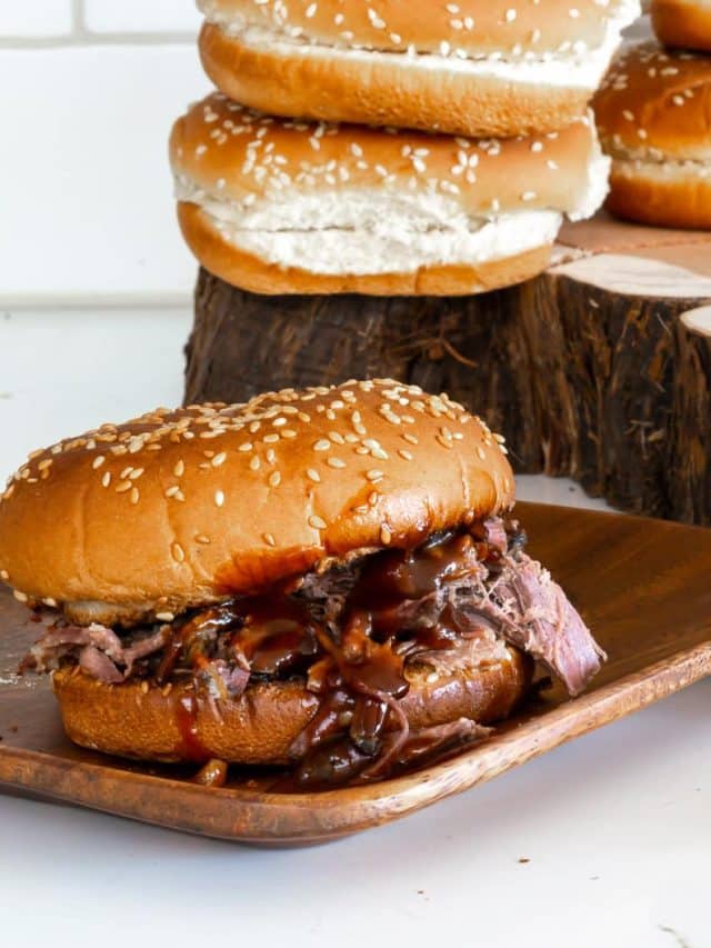 Sandwiches with slow cooker pulled beef and barbecue sauce.