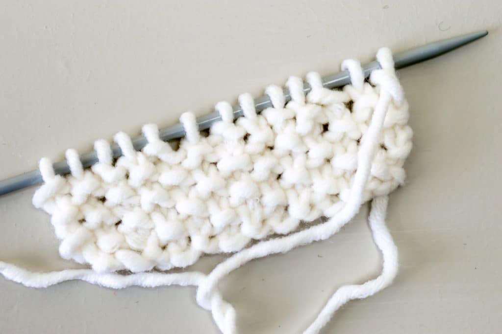 Seed stitch on knitting needles.