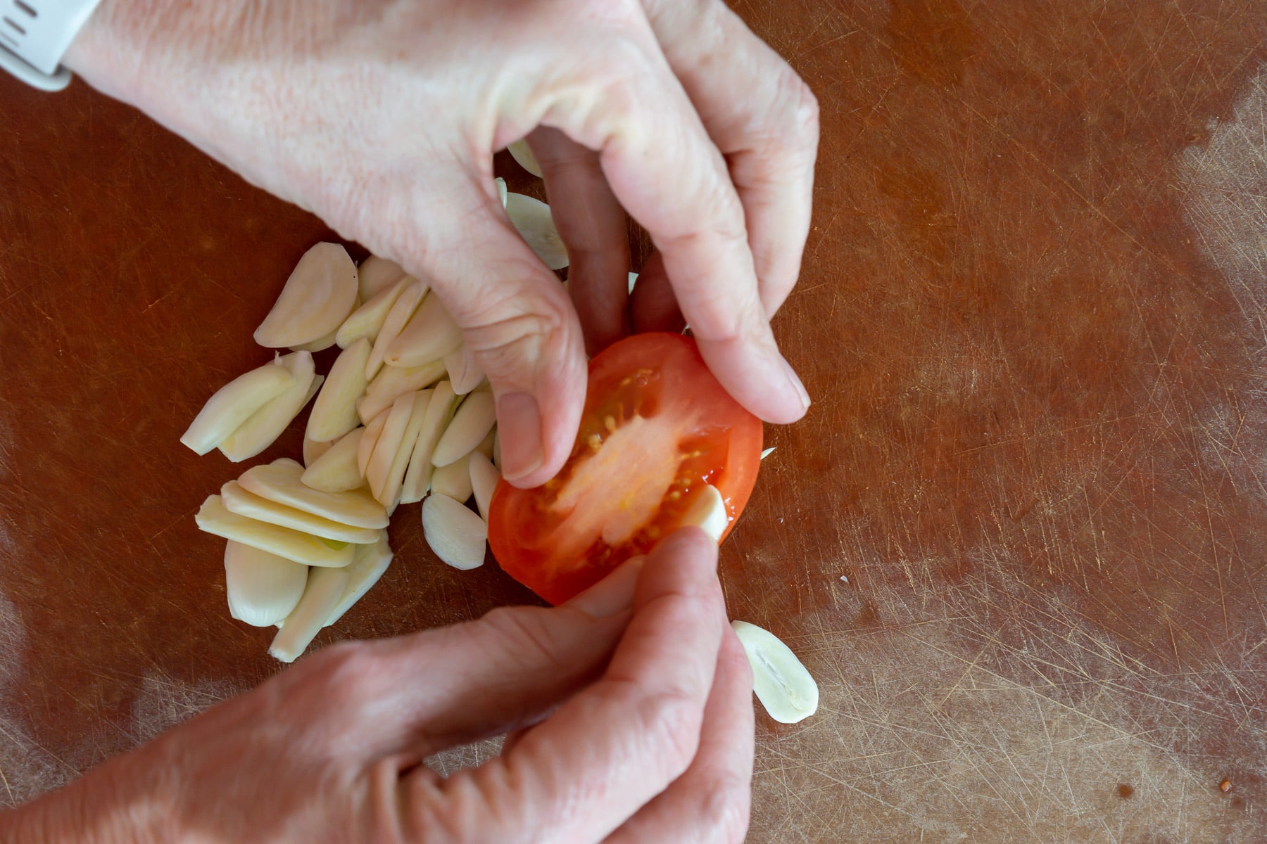 insert a sliver of garlic into tomato half before roasting.
