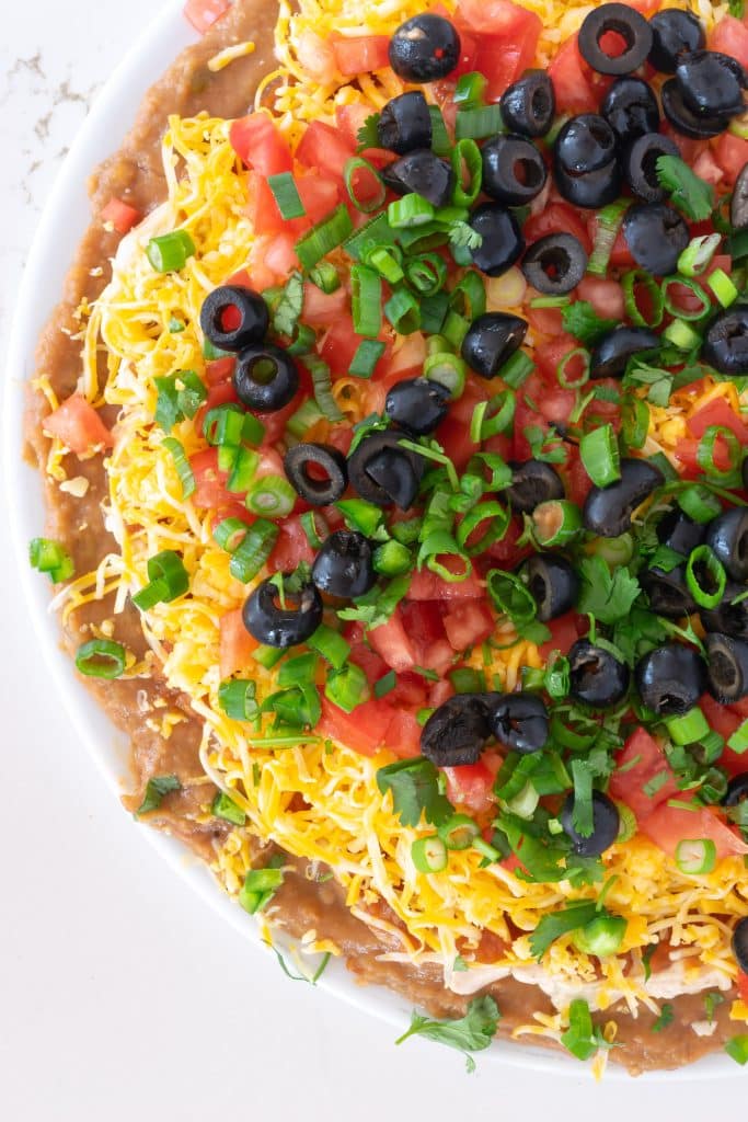 Overhead view of side of layered taco dip.