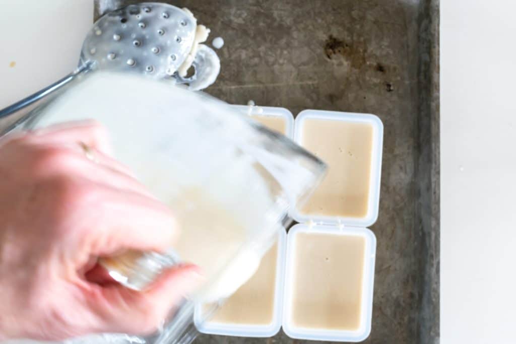 Pouring melted soap into molds.