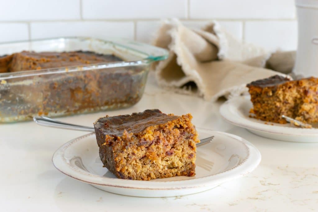 Date cake on a plat and in a baking dish in the background.
