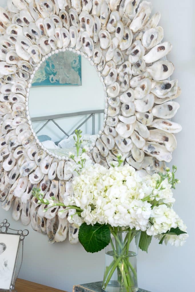 Oyster shell mirror with flowers.