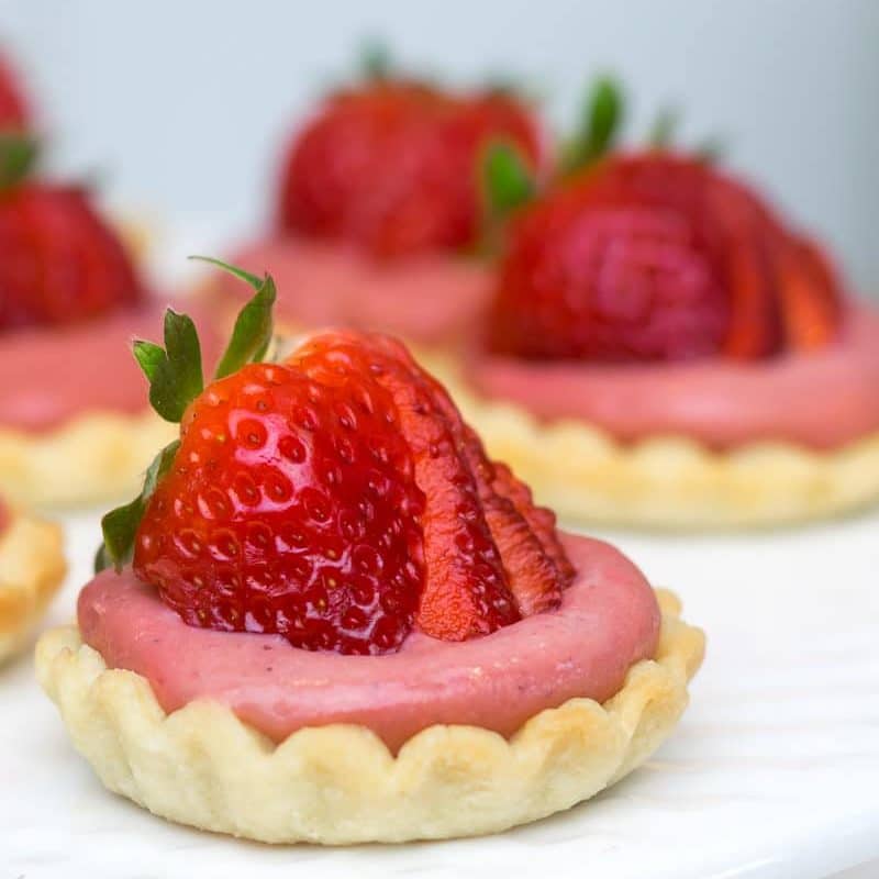 Mini Strawberry Tarts on a cake stand.