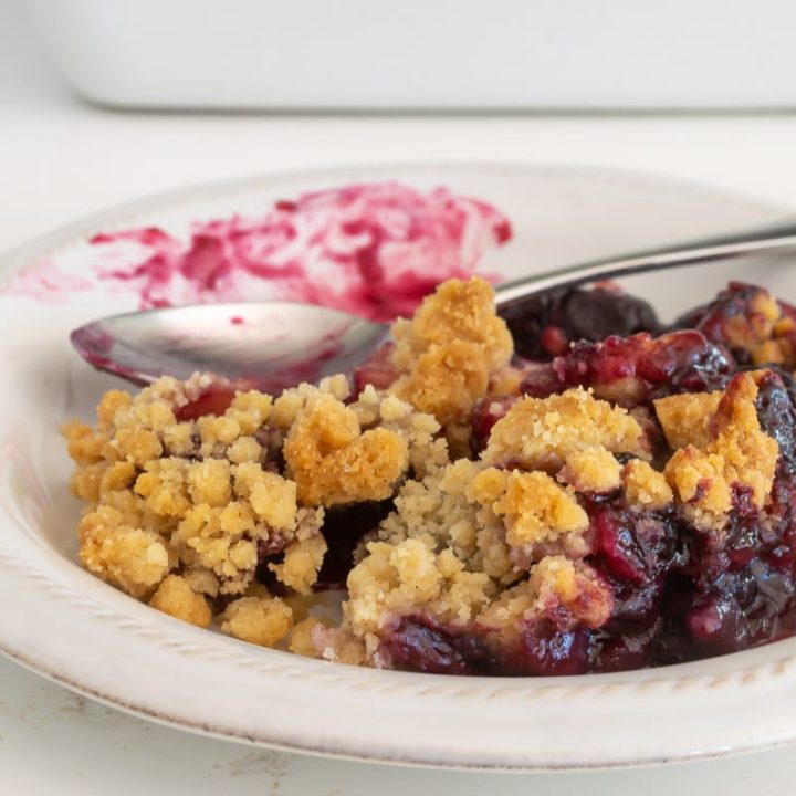 Blueberry and Apple Crumble on a plate with a fork.