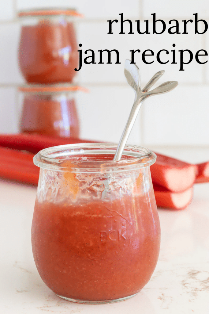 Jar of rhubarb jam with a silver spoon.