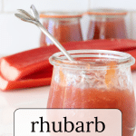 Jar of rhubarb jam with a silver spoon.