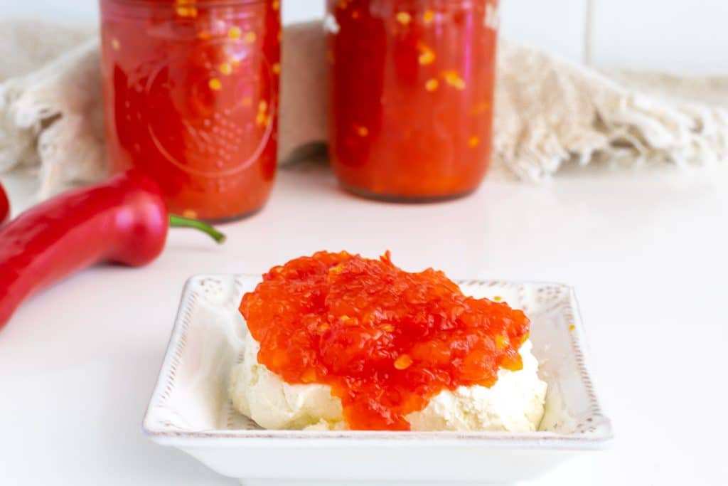 jars of red pepper jelly and red pepper jelly over cream cheese.