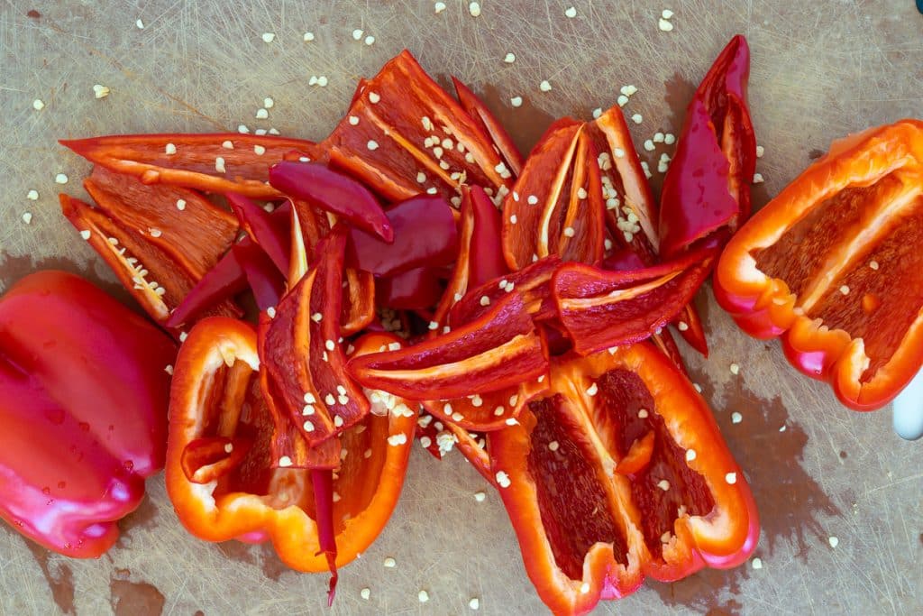 Cut bell pepper and red chiles.