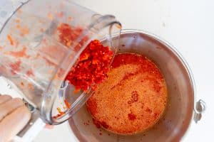 Chopped chiles into red pepper/vinegar puree.