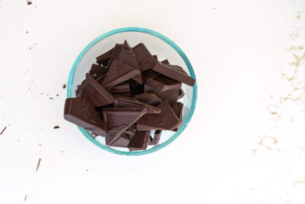 broken pieces of chocolate in a microwave safe bowl.