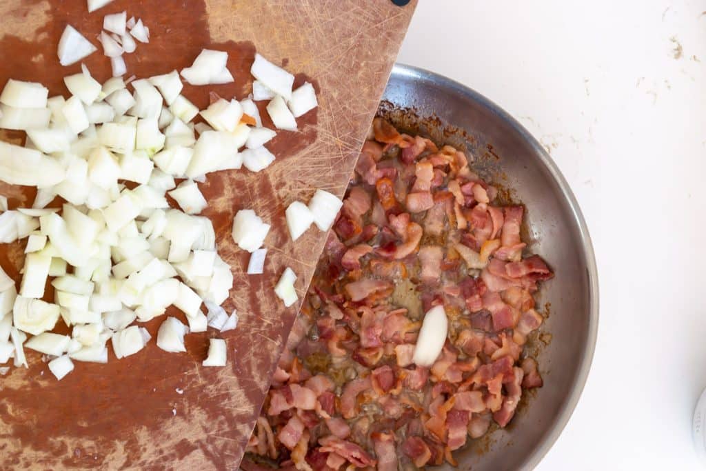 Add onion to cooked bacon.