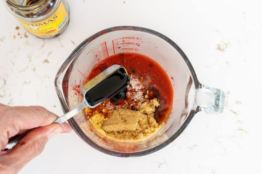 Add molasses to tomato sauce.