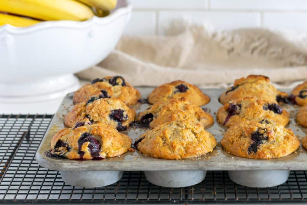 Baked banana blueberry muffins in muffin tin.
