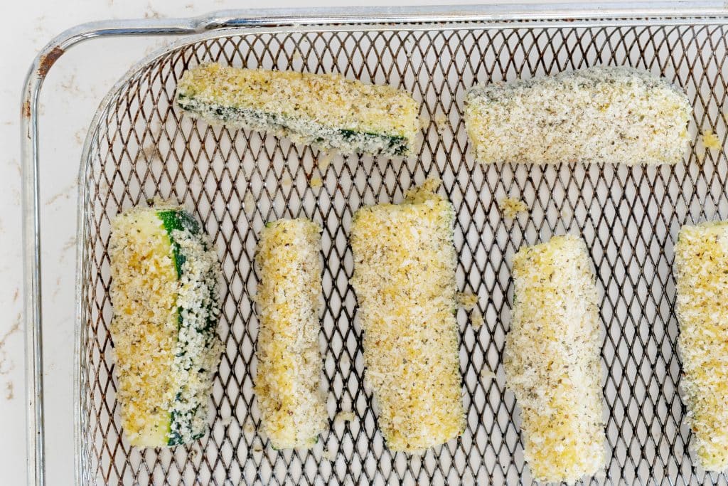 Breaded zucchini on tray.
