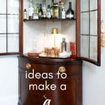 Finished DIY Bar Cabinet with lamp and barware.