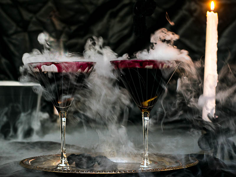 Black Widow Martini Cocktail with smoke coming out of glass.