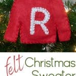 A red felt Christmas sweater ornament with a letter R.