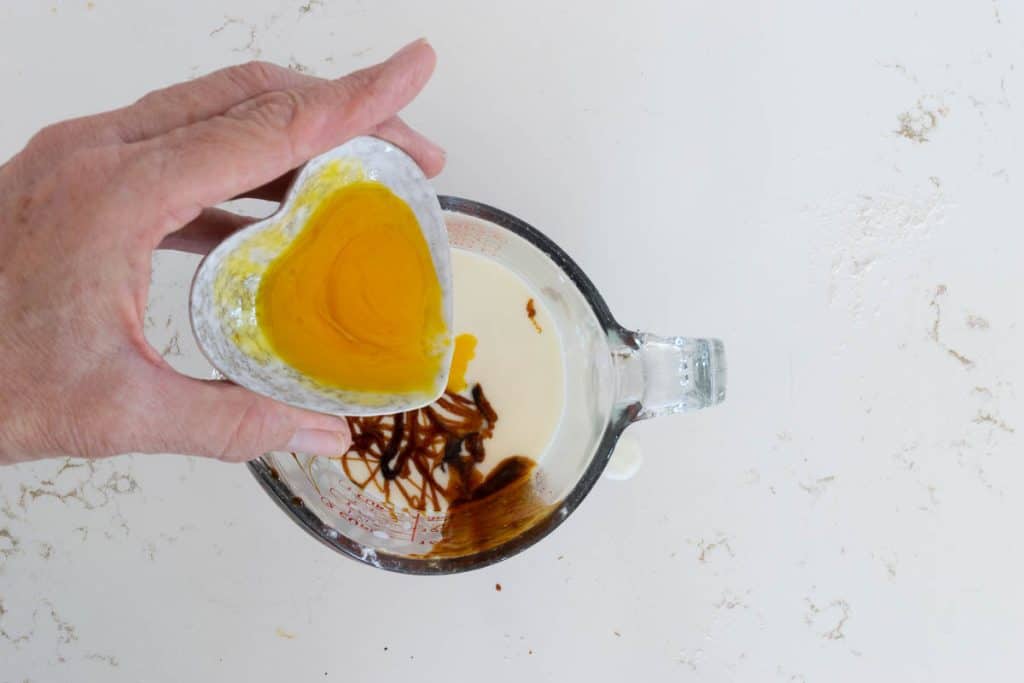 Add egg yolk to cream and molasses.
