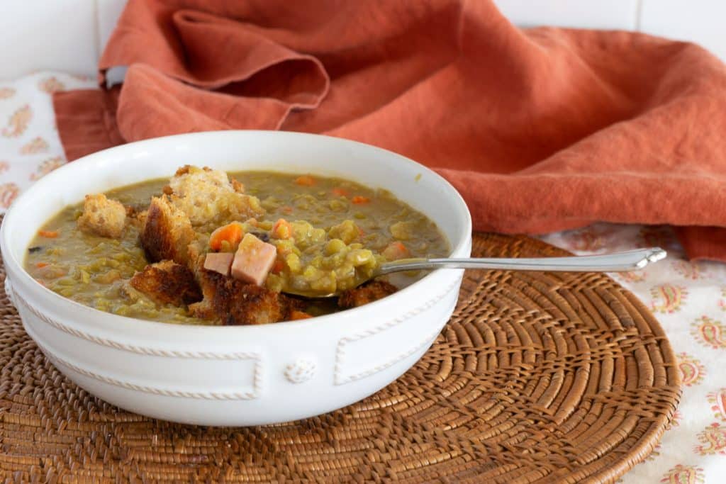 Crock Pot Pea Soup with Ham in a white soup bowl.
