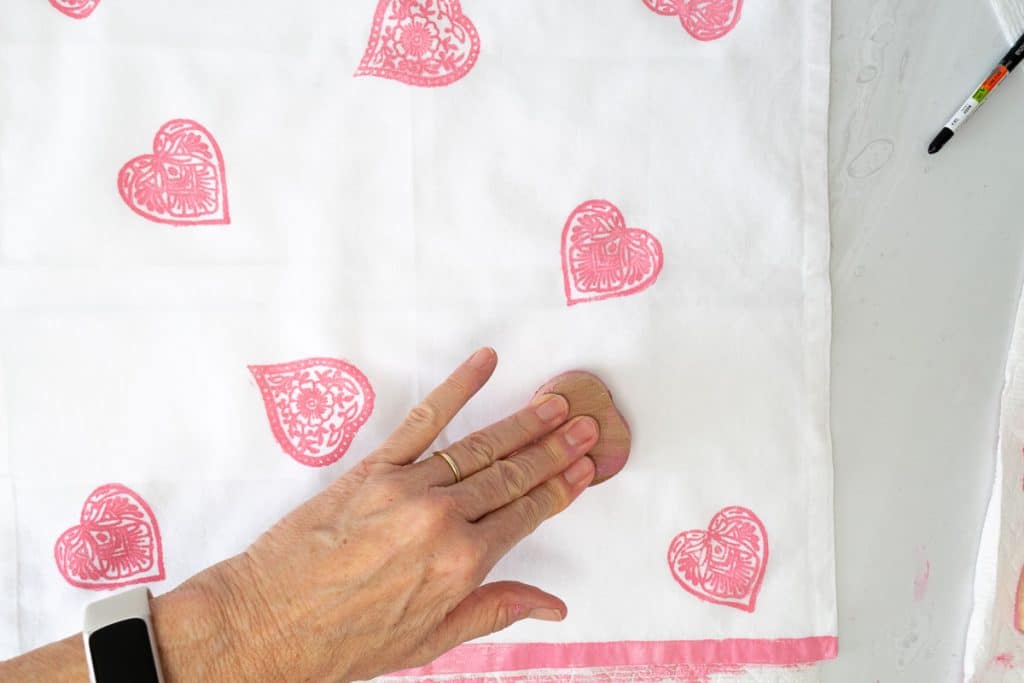 Stamp heart on fabric.