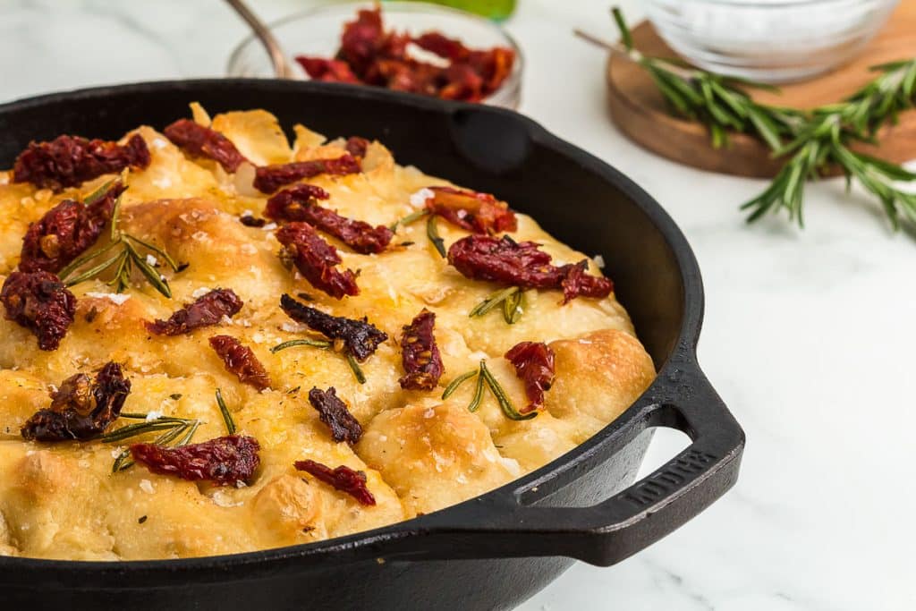 Sourdough Focaccia Bread in a cast iron skillet.